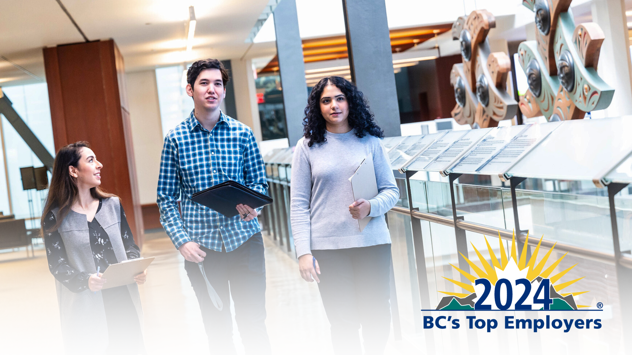 UBC 2024 BC's Top Employers | three employees walking indoors
