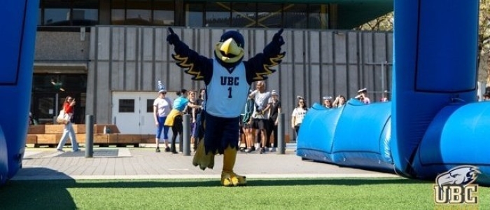 Thunderbirds mascot running across finish line with wings open