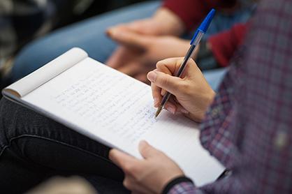 A person taking notes.