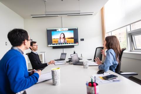 People sitting looking at a screen