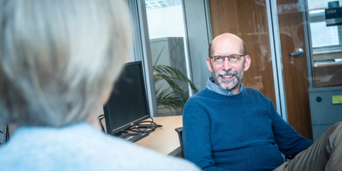 Two people sitting in an office and having a meeting.