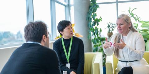 Three people seated in discussion