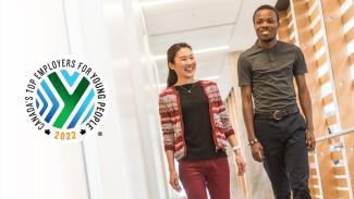 two people walking down hallway