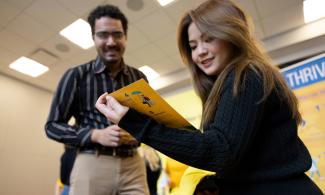 Two people reading Thrive materials