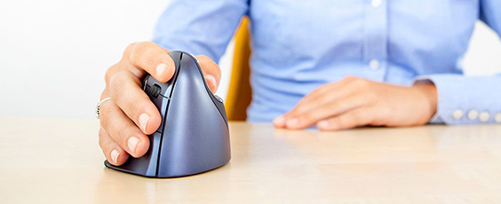 a hand using a vertical ergonomic mouse on a wooden table