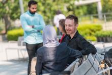 Staff talking on bench