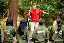 Person standing in forest with group