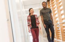 two young people walking down hallway