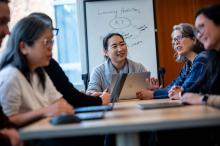 Staff members seated at a table in a workshop