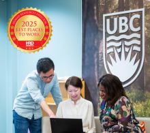 Three people collaborate at a table with a laptop in front of a UBC logo; a "2025 Best Places to Work" award badge appears in the image corner.